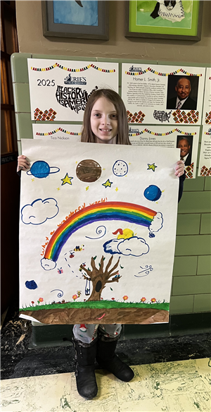 Edison student Ella shows a picture with her vision of a wonderful world. Features tree with swing, rainbow and planets.